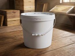 18 liter plastic bucket of honey in an extraction room