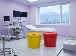 Yellow and red 11.5 liter medical waste buckets in an endoscopy room