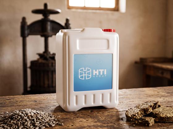 White 10 L plastic jerry can with cap on an oil mill workbench in the Chuy Valley next to a pile of sunflower seeds